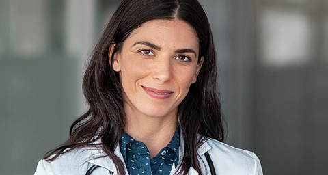 Confident female doctor smiling at camera.